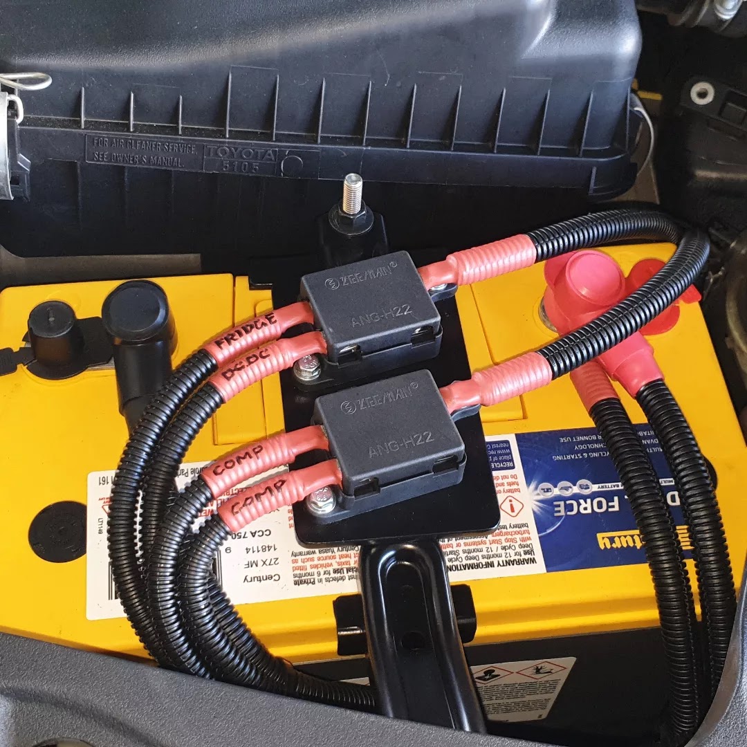Engine bay dual battery install with a Century battery and two labelled ANL fuse holders