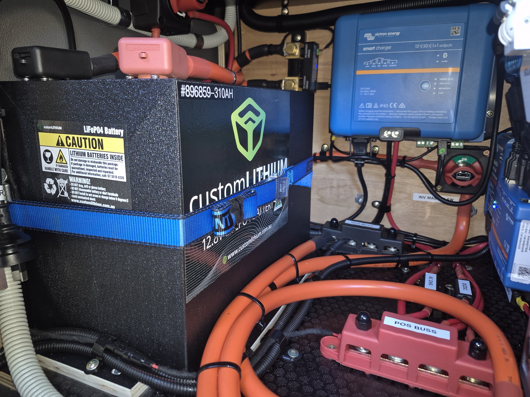 A 310Ah customLITHIUM battery and Victron smart charger wired into a vehicle fit-out, with labelled positive and negative bus bars